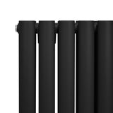 Schwarzer ovaler Röhrenheizkörper mit glatter, mattschwarzer Oberfläche und modernen Chrom-Thermostatventilen, ideal für stilvolle Heizlösungen