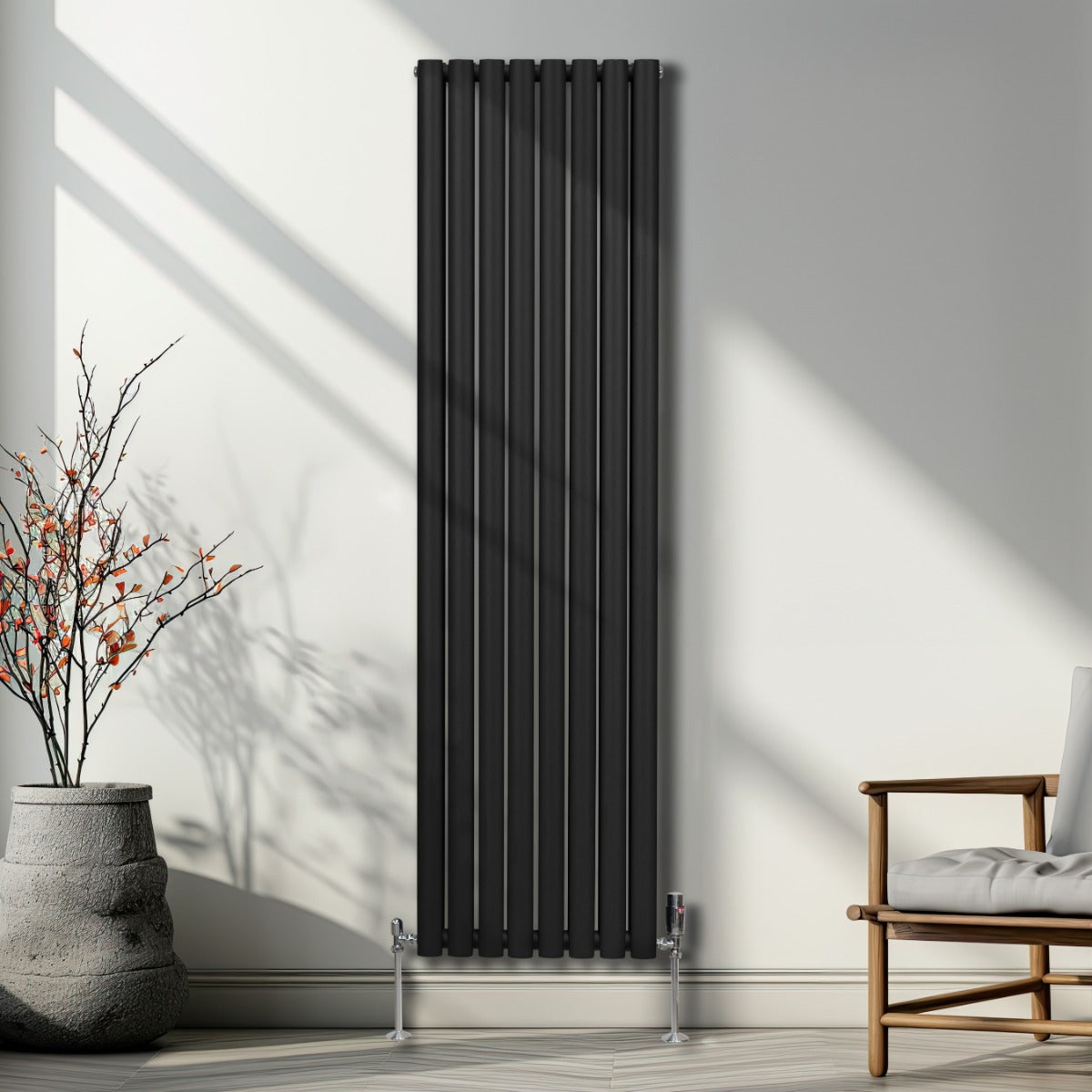 Schwarzer ovaler Röhrenheizkörper mit Chrom-Thermostatventilen, 1800mm x 480mm, elegant an einer hellen Wand, umgeben von minimalistischer Einrichtung