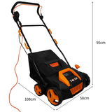 Schwarzer T-Mech Staubsauger für Kunstrasen mit orangefarbenen Akzenten, großen Rädern und ergonomischem Griff, ideal für die Rasenpflege