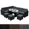 Schwarzes Polyrattan Gartenmöbel Set mit bequemen, grauen Kissen, einem eleganten Glastisch und passenden Hockern für stilvolle Außenbereiche