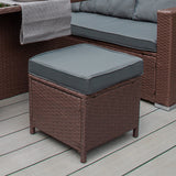Schwarzes Polyrattan Gartenmöbel Set mit grauem Kissen, bestehend aus einem quadratischen Hocker und einer bequemen Sitzbank auf Holzdeck