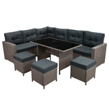 Rattan-Eckset in Grau mit bequemen, dunklen Polstern und einem eleganten, schwarzen Tisch, ideal für Garten oder Terrasse