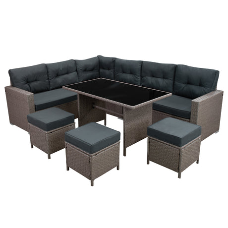 Rattan-Eckset in Grau mit bequemen, dunklen Polstern und einem eleganten, schwarzen Tisch, ideal für Garten oder Terrasse