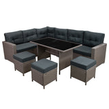 Elegantes Polyrattan Gartenmöbel Set in Grau mit bequemen, dunkelgrauen Polstern, bestehend aus einer L-förmigen Couch und einem Tisch mit Glasplatte