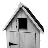 Grau gestrichenes Gartenhaus aus Holz mit einem spitzen Dach, einer kleinen Fensteröffnung und einer stabilen Tür mit schwarzem Beschlag