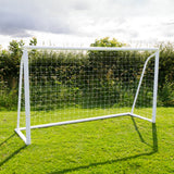 Fußballtor in Weiß mit stabiler Netzstruktur, auf grünem Rasen platziert, ideal für Garten- oder Freizeitspiele, inklusive Tragetasche und Torwand