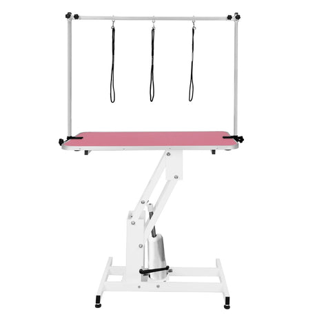 Hydraulischer Pflegetisch in Weiß mit einer rosa Tischplatte, verstellbar, ausgestattet mit drei Haltegurten für Haustiere, stabil und funktional