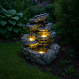Rustikale Wasseranlage "Rustic Rapids" aus grauem Stein mit sanft fließendem Wasser und warmen LED-Lichtern, ideal für Gärten und Terrassen