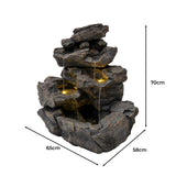 Rustikale Wasseranlage "Rustic Rapids" aus grauem Kunststein, mit mehreren Ebenen, sanft fließendem Wasser und integrierten LED-Lichtern für stimmungsvolle Beleuchtung