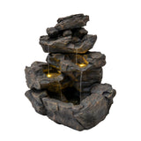 Rustikale Wasseranlage "Rustic Rapids" aus grauem Kunststein mit mehreren Ebenen, sanftem Wasserfluss und integrierten LED-Lichtern für stimmungsvolle Beleuchtung