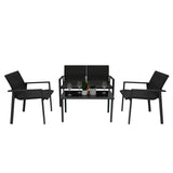 Schwarzes Rattan Terrassenmöbel Set mit zwei Stühlen und einem Tisch, ausgestattet mit Glasplatte und dekorativen Elementen wie Gläsern und einer Flasche Sekt