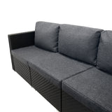 Modulares 7-teiliges Rattan-Möbelset in Schwarz mit weichen, grauen Kissen und einer praktischen Aufbewahrungsbox für zusätzlichen Stauraum