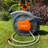 Graue Schlauchtrommel mit orangefarbenen Akzenten, ausgestattet mit einem Gartenschlauch und einer Spritzdüse, auf grünem Rasen platziert