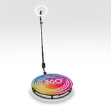 Bunte 360 Grad Fotokabine mit einem runden, farbenfrohen Podest und einem Ringlicht, ideal für kreative Fotoerlebnisse auf Veranstaltungen