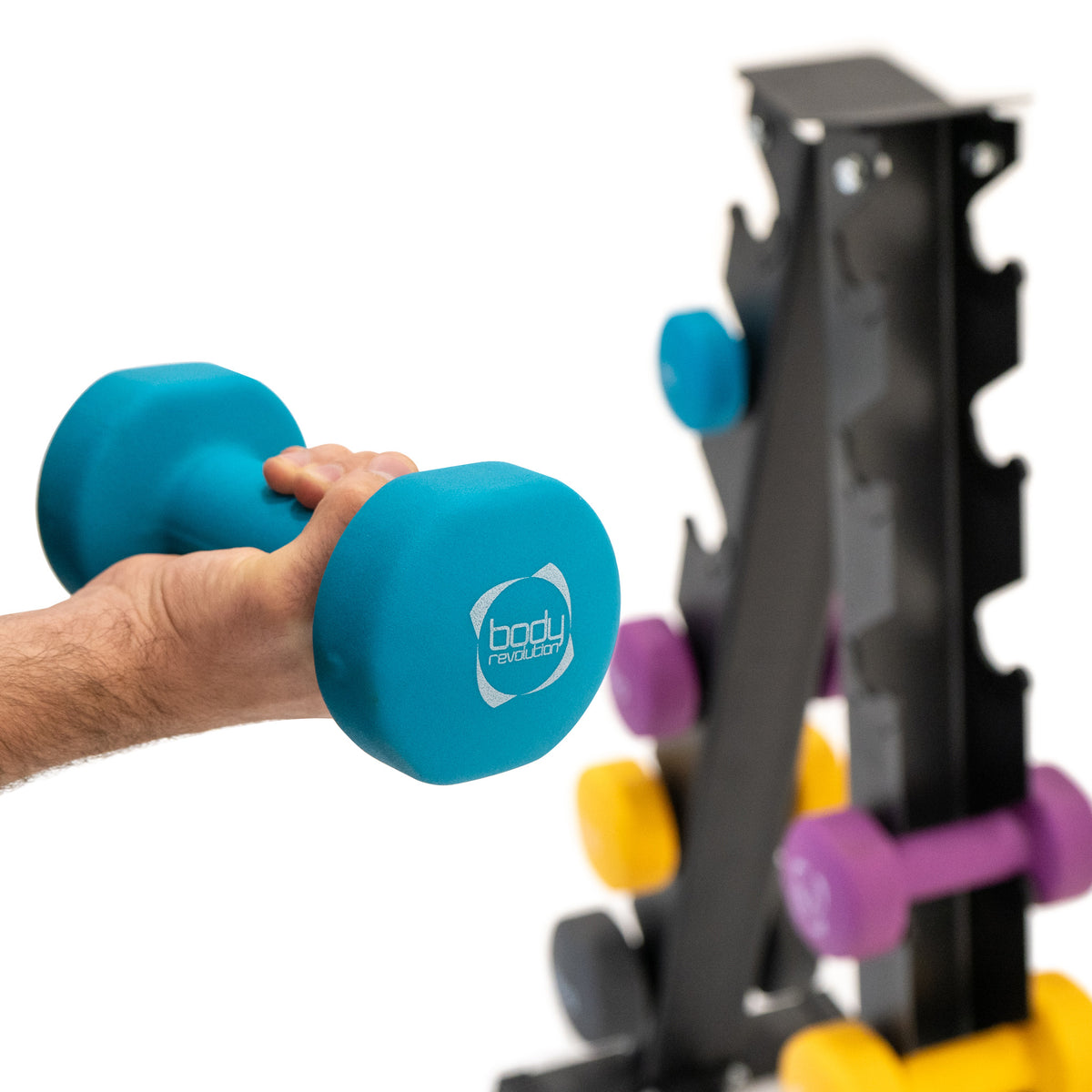 Neopren Hantel in leuchtendem Blau mit ergonomischem Griff, gehalten von einer Hand, neben einem stabilen Hantelständer mit bunten Gewichten