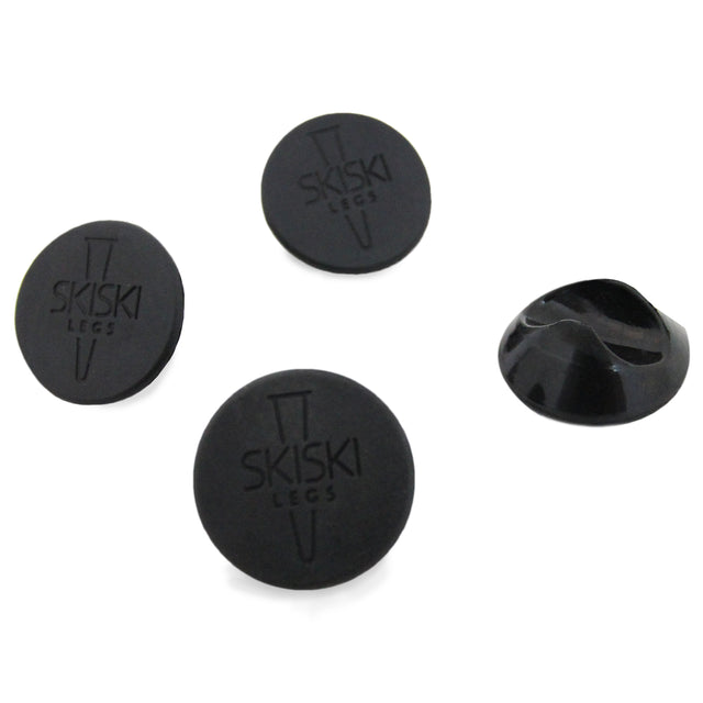 Schwarze Haarnadelbein-Schoner im 4er-Set, aus robustem Gummi, rund mit glatter Oberfläche und eingraviertem Logo für besseren Halt